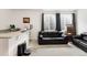 Spacious living room with comfortable seating, a wet bar, and carpeted floors at 17247 E 103Rd Ave, Commerce City, CO 80022