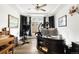 A comfortable and well-equipped home office space with an exercise bike, a desk and a neutral design at 17247 E 103Rd Ave, Commerce City, CO 80022