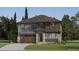 Charming two-story home featuring a mix of stone and wood siding, a welcoming porch, and an attached two-car garage at 15265 Fillmore St, Thornton, CO 80602