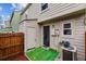A cozy backyard, featuring artificial turf, a wooden fence and exterior access door at 1612 S Idalia Cir # A, Aurora, CO 80017