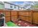 Fenced backyard with wood chips and wood planter at 1612 S Idalia Cir # A, Aurora, CO 80017