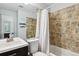 Tiled bathroom featuring vanity, toilet and shower with brown stone design at 1612 S Idalia Cir # A, Aurora, CO 80017
