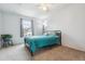 Bright bedroom with large window, teal comforter, neutral carpet, and ceiling fan at 1612 S Idalia Cir # A, Aurora, CO 80017