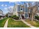 Charming townhome exterior featuring blue siding, a well-maintained lawn, and mature trees in a Gathering-friendly neighborhood at 1612 S Idalia Cir # A, Aurora, CO 80017