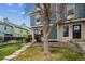 Charming townhome exterior featuring blue siding, a well-maintained lawn, and mature trees in a Gathering-friendly neighborhood at 1612 S Idalia Cir # A, Aurora, CO 80017