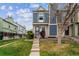 Inviting townhouse featuring blue accents, complemented by a green lawn and concrete steps at 1612 S Idalia Cir # A, Aurora, CO 80017