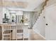 Modern kitchen with white cabinets, stainless steel appliances, breakfast bar, and staircase access at 1612 S Idalia Cir # A, Aurora, CO 80017