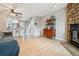 Open living room and kitchen area featuring a cozy fireplace, wood floors, and open floor plan to the kitchen at 1612 S Idalia Cir # A, Aurora, CO 80017
