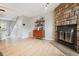 Inviting living room with a stone fireplace, wood floors, and an open layout perfect for entertaining at 1612 S Idalia Cir # A, Aurora, CO 80017