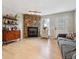 Cozy living room featuring a stone fireplace, hardwood floors, and ample natural light from the window at 1612 S Idalia Cir # A, Aurora, CO 80017