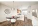 Dining area with kitchen views, modern light fixture, and breakfast bar at 5653 W 10Th Ave, Lakewood, CO 80214