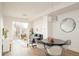 Bright dining area with modern table and chairs, adjacent to living room at 5653 W 10Th Ave, Lakewood, CO 80214