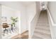 Modern staircase with light gray carpeting and home office view at 5653 W 10Th Ave, Lakewood, CO 80214