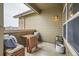 Cozy balcony with outdoor seating, wood-paneled walls, and neighborhood views at 3205 S Walden Ct # H, Aurora, CO 80013