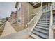 A row of townhomes featuring a combination of stone and siding exterior, each with its own stairway and entrance at 3205 S Walden Ct # H, Aurora, CO 80013
