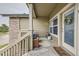 Inviting front porch featuring a wooden bench with blue cushions and a welcoming wreath on the door at 3205 S Walden Ct # H, Aurora, CO 80013