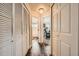 Hallway with hardwood floors leading to the bathroom and office at 3205 S Walden Ct # H, Aurora, CO 80013