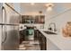 Modern kitchen featuring stainless steel appliances, dark wood cabinetry, and a stylish design for cooking and entertaining at 3205 S Walden Ct # H, Aurora, CO 80013