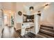 Well-lit kitchen with dark wood cabinets, stainless steel appliances, and a breakfast bar with modern stools at 3205 S Walden Ct # H, Aurora, CO 80013