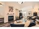 Bright living room featuring a fireplace, high ceilings, and comfortable seating, perfect for relaxation and entertaining guests at 3205 S Walden Ct # H, Aurora, CO 80013