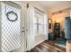 Bright living area featuring a window, door, and wood floors at 3205 S Walden Ct # H, Aurora, CO 80013