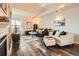 Cozy living room with hardwood floors, comfortable furniture, and ample natural light, creating an inviting atmosphere at 3205 S Walden Ct # H, Aurora, CO 80013