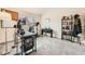 Office features a vaulted ceiling, large window, desk setup, piano, and bookshelf at 3205 S Walden Ct # H, Aurora, CO 80013