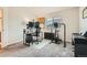 Bright office with a large window, desk and computer setup, exercise equipment, and piano at 3205 S Walden Ct # H, Aurora, CO 80013
