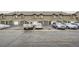 Exterior shot of townhomes with parking spaces and cars parked in front at 3205 S Walden Ct # H, Aurora, CO 80013