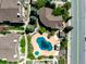 Aerial view of a community pool, landscaped grounds, and surrounding townhomes at 8705 W Berry Ave # 204, Littleton, CO 80123