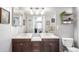 Bathroom features a double sink vanity, large mirror and decorative plants at 8705 W Berry Ave # 204, Littleton, CO 80123
