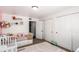 Well-lit bedroom with closet, white accent wall, day bed, rug and accessories at 8705 W Berry Ave # 204, Littleton, CO 80123