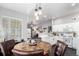 Dining room with a view to the living room, kitchen, and outdoor patio at 8705 W Berry Ave # 204, Littleton, CO 80123