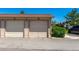 Exterior shot of a two-car garage with updated doors and fresh landscaping at 8705 W Berry Ave # 204, Littleton, CO 80123