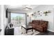 Cozy living room with a sliding glass door to the patio and a ceiling fan at 8705 W Berry Ave # 204, Littleton, CO 80123