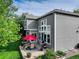 Aerial view of a backyard with a well-manicured lawn, patio set, and an attractive gray two-story house at 3207 Opal Ln, Superior, CO 80027