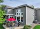Backyard patio with seating, grill, landscaping, and large windows at 3207 Opal Ln, Superior, CO 80027