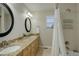 Bathroom featuring a double sink vanity with granite counters and a shower over tub at 3207 Opal Ln, Superior, CO 80027