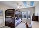Bedroom with bunk beds, a ceiling fan and natural light streaming through the window at 3207 Opal Ln, Superior, CO 80027