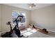 Brightly lit bedroom with an exercise bike, rowing machine and large window at 3207 Opal Ln, Superior, CO 80027