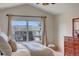 Inviting bedroom with vaulted ceilings, large window, and ample natural light at 3207 Opal Ln, Superior, CO 80027