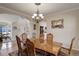 Elegant dining room featuring a wooden table, chandelier, and access to the kitchen at 3207 Opal Ln, Superior, CO 80027