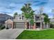 Beautiful two-story home showcasing brick accents, a well-manicured lawn, and a three-car garage at 3207 Opal Ln, Superior, CO 80027