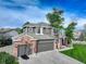Traditional two-story home with brick accents, attached garage, and green lawn at 3207 Opal Ln, Superior, CO 80027