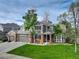 Beautiful two-story home featuring an attached garage, brick facade, and lush green lawn at 3207 Opal Ln, Superior, CO 80027