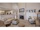Open-concept living room boasts fireplace, built-in cabinets, and a view to the kitchen at 3207 Opal Ln, Superior, CO 80027