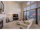 Spacious living room features tall windows, a fireplace, and comfortable seating at 3207 Opal Ln, Superior, CO 80027