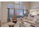 Bright living room features large windows, neutral decor, and comfortable seating at 3207 Opal Ln, Superior, CO 80027