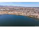 Beautiful aerial view of a lakeside neighborhood with lush trees and a mountain backdrop at 7700 W Grand Ave, Littleton, CO 80123