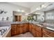 Well lit bathroom boasts double sinks with granite counters, tiled floors, and a soaking tub with decorative tile surround at 7700 W Grand Ave, Littleton, CO 80123